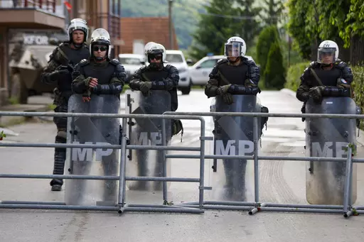 Polish soldiers, part of the peacekeeping mission in Kosovo KFOR, guard a municipal building in the town of Zvecan, northern Kosovo, Tuesday, May 30, 2023. Troops from the NATO-led peacekeeping force in Kosovo have used metal fences and barbed wire to beef up positions in a northern town following clashes with ethnic Serbs that left 30 soldiers wounded. (AP Photo/Marjan Vucetic)(AP Photo/Marjan Vucetic)