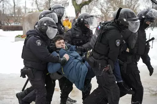 Police detain a man trying to lay flowers to honor Alexei Navalny at a monument in St. Petersburg, Russia, to victims of Soviet repression, on Saturday, Feb. 17, 2024. Over the last decade, Vladimir Putin's Russia evolved from a country that tolerates at least some dissent to one that ruthlessly suppresses it. Arrests, trials and long prison terms — once rare — are commonplace. (AP Photo, File)