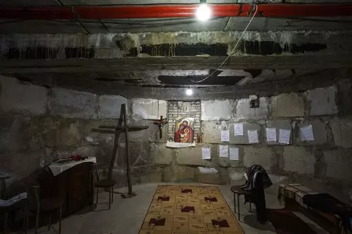 A makeshift chapel in the bomb shelter nuns have prepared to take shelter in when air raids go off, at the Hoshiv Women's Monastery, where nuns have been taking in internally displaced people fleeing the war, in Ivano-Frankivsk region, western Ukraine, Wednesday, April 6, 2022. Mattresses, blankets and benches also line the basement. But even when there are no sirens, children happily use the cavernous underground space. (AP Photo/Nariman El-Mofty)