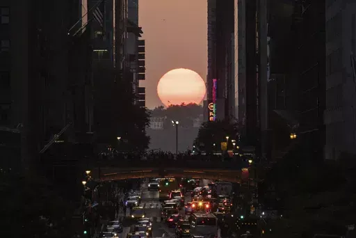 The sun sets between buildings along 42nd Street in New York during a phenomenon known as "Manhattanhenge," May 30, 2023. Twice per year, New Yorkers and visitors are treated to a phenomenon known as Manhattanhenge, when the setting sun aligns with the Manhattan street grid and sinks below the horizon framed in a canyon of skyscrapers. Manhattanhenge happens for the first time this year on Tuesday, May 28, at 8:13 p.m. and Wednesday, May 29, at 8:12 p.m. (AP Photo/Yuki Iwamura, File)