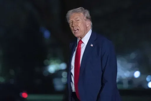 President Donald Trump talks to reporters as he walks on the South Lawn of the White House, in Washington, Sunday, March 30, 2025. (AP Photo/Jose Luis Magana)