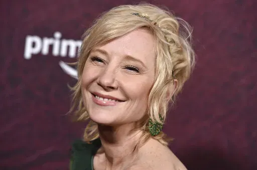 Anne Heche arrives at the premiere of "The Tender Bar" at the TCL Chinese Theatre, on Dec. 12, 2021, in Los Angeles. The coroner's office says actor Heche died from burns and inhalation injury after her fiery car crash and the death has been ruled an accident. The cause of her death was released on the Los Angeles County coroner's website Wednesday, Aug. 17, 2022, although a formal autopsy report is still being completed. (Photo by Jordan Strauss/Invision/AP, File)