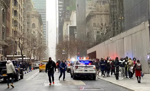 In this photo from a social media post by Scott Cowdrey, people are evacuated from the Museum of Modern Art where a stabbing occurred, Saturday, March 12, 2022, in New York. Police said two people were stabbed inside MoMA and in stable condition at Bellevue Hospital. (Scott Cowdrey via AP)
