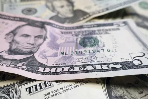 FILE- This Wednesday, June 6, 2018, file photo shows U.S. currently in New York. The “infinite banking” movement is trending on TikTok as a way to create wealth. It sounds simple: Use your cash value life insurance policy to take out low-interest loans and finance large purchases like college tuition and home renovations. (AP Photo/Ted Shaffrey, File)