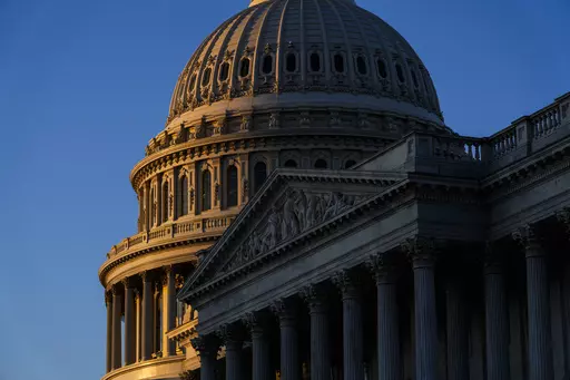The rising sun illuminates the U.S. Capitol, Dec. 19, 2022 in Washington. A new poll finds that most U.S. adults say they are highly concerned about the impact on the national economy if the U.S. debt limit is not increased and the government defaults on its loans. That's according to a survey from The Associated Press-NORC Center for Public Affairs Research. (AP Photo/Matt Rourke, File)