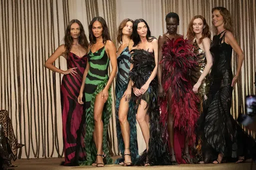 Models Joan Smalls, Isabeli Fontana, Natasha Poly, Maria Carla Boscono, Alex Wek, Karen Elson and Eva Herzigova wear a creations as part of the Roberto Cavalli Spring Summer 2025 collection, that was presented in Milan, Italy, Wednesday, Sept. 18, 2024. (AP Photo/Luca Bruno)