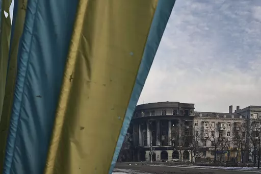 A Ukrainian flag waves in the city center damaged by Russian shelling in Bakhmut, Donetsk region, Ukraine, Friday, Feb. 10, 2023. Despite Russian claims to have captured the Ukrainian city of Bakhmut, top Ukrainian military leaders insist the grinding nine-month battle there is not over. Although Ukraine now controls only a small part of the city, Kyiv says its troops played a key role in the strategy of exhausting Russian forces and will carry on with the fighting.(AP Photo/Libkos, File)