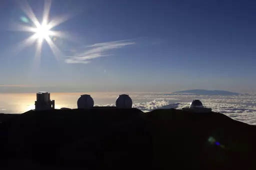 The sun sets behind telescopes on July 14, 2019, at the summit of the Big Island's Mauna Kea in Hawaii. For over 50 years, telescopes have dominated the summit of Mauna Kea, a place sacred to Native Hawaiians and one of the best places in the world to study the night sky. That's now changing with a new state law saying Mauna Kea must be protected for future generations and that science must be balanced with culture and the environment. (AP Photo/Caleb Jones, File)