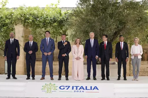 From left, European Council President Charles Michel, German Chancellor Olaf Scholz, Canada's Prime Minister Justin Trudeau, French President Emmanuel Macron, Italian Prime Minister Giorgia Meloni, U.S. President Joe Biden, Japan's Prime Minister Fumio Kishida, Britain's Prime Minister Rishi Sunak and European Commission President Ursula von der Leyen stand for a group photo at the G7, Thursday, June 13, 2024, in Borgo Egnazia, Italy. (AP Photo/Alex Brandon)