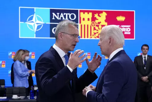 NATO Secretary General Jens Stoltenberg, left, speaks with U.S. President Joe Biden during a round table meeting at a NATO summit in Madrid, Spain on Wednesday, June 29, 2022. North Atlantic Treaty Organization heads of state will meet for a NATO summit in Madrid from Tuesday through Thursday. (AP Photo/Bernat Armangue)