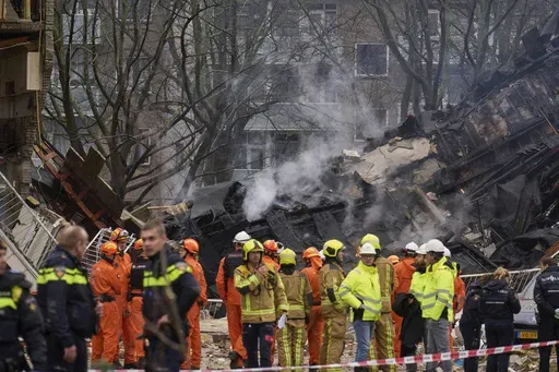 Firefighters stand by a building destruction at the site of an explosion which destroyed several apartments and injured multiple people, at The Hague, Saturday, Dec. 7, 2024. (AP Photo/Phil Nijhuis)