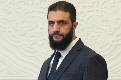 Syria's de facto leader Ahmad al-Sharaa, formerly known as Abu Mohammed al-Golani, walks in the presidential palace ahead of his meeting with Walid Ellafi, Libyan minister of state for communication and political affairs, in Damascus, Dec. 28, 2024. (AP Photo/Mosa'ab Elshamy, File)