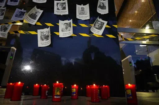 Photos of slain journalists are displayed on a wall during a vigil to protest the murder of journalist Fredid Roman, outside Mexico's Attorney General's office in Mexico City, Wednesday, Aug. 24, 2022. Roman was the 15th media worker killed so far this year in Mexico, where it is now considered the most dangerous country for reporters outside a war zone. (AP Photo/Eduardo Verdugo, File)