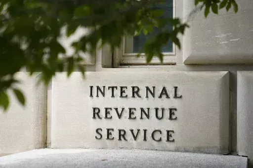 A sign outside the Internal Revenue Service building is seen, May 4, 2021, in Washington. Tax Day reveals a major split in how Joe Biden and Donald Trump would govern: The presidential candidates have conflicting ideas about how much to reveal about their own finances and the best ways to boost the economy through tax policy. (AP Photo/Patrick Semansky, File)