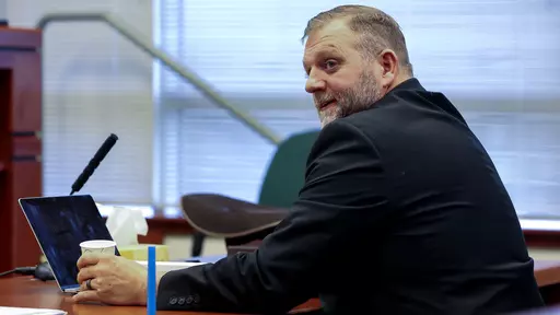 Ammon Bundy glances toward the prosecution table during a pause in his trial to clarify a line of questioning with the jury dismissed in Ada County Magistrate Judge Kim Dale's courtroom on March 15, 2022, in Boise, Idaho. A jury on Monday, July 24, 2023, awarded an Idaho hospital more than $50 million in damages in a defamation case the institution brought against far-right activist Ammon Bundy and others. (Darin Oswald/Idaho Statesman via AP, File)
