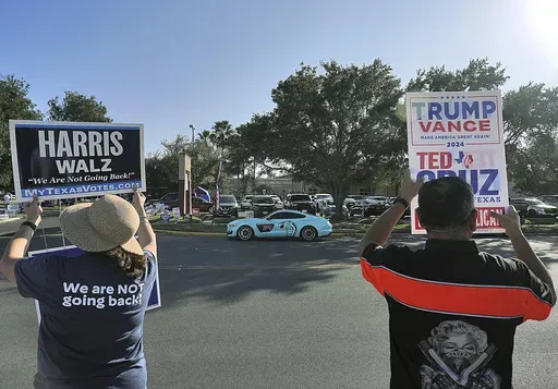 Supporters of democratic presidential nominee Vice President Kamala Harris and Republican presidential nominee former President Donald Trump campaign outside a polling place, Nov. 5, 2024, in McAllen, Texas.(Joel Martinez/The Monitor via AP, File)/The Monitor via AP)