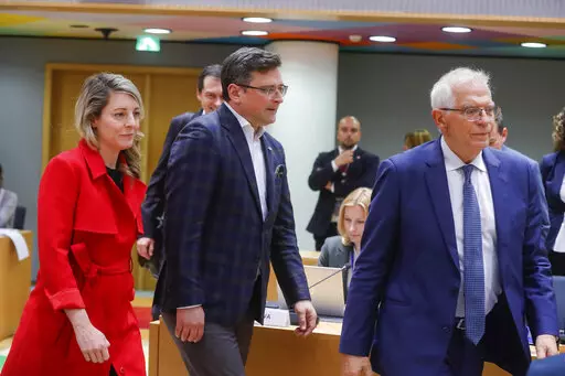 Ukraine's foreign minister Dmytro Kuleba, center, Canada's foreign minister Melanie Joly, left, and European Union foreign policy chief Josep Borrell arrive at a meeting of EU foreign ministers at the European Council building in Brussels, Monday, May 16, 2022. European Union foreign ministers on Monday will discuss current affairs and have an exchange of views on the Russian aggression against Ukraine and the Global Gateway. (Stephanie Lecocq/Pool Photo via AP)