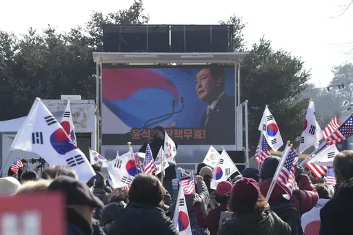 A picture of impeached South Korean President Yoon Suk Yeol is seen on the screen during a rally to oppose his impeachment outside a detention center in Uiwang, South Korea, Friday, Jan. 17, 2025. (AP Photo/Lee Jin-man)