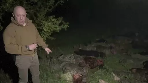 In this handout image taken from a video released by Prigozhin Press Service on Friday, May 5, 2023, head of Wagner Group Yevgeny Prigozhin stands in front of multiple bodies lying on the ground in an unknown location. The owner of Russia's private military company Wagner, Yevgeny Prigozhin, on Friday threatened to pull out Wagner forces from the embattled Ukrainian city of Bakhmut next week, accusing Russia's military command of starving the group of ammunition. (Prigozhin Press Service via AP)
