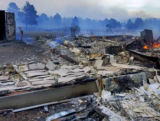 This Wednesday April 20, 2022, photo provided by Bill Wells shows his home on the outskirts of Flagstaff, Ariz., destroyed by a wildfire on Tuesday, April 19, 2022. The wind-whipped wildfire has forced the evacuation of hundreds of homes and animals. (Bill Wells via AP)
