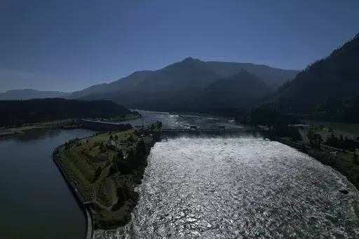 Water spills over the Bonneville Dam on the Columbia River, which runs along the Washington and Oregon state line, on Tuesday, June 21, 2022. The U.S. government on Tuesday, June 18, 2024, acknowledged for the first time the harms that the construction and operation of dams on the Columbia and Snake rivers in the Pacific Northwest have caused Native American tribes, issuing a report that details how the unprecedented structures devastated salmon runs, inundated villages and burial grounds, and c