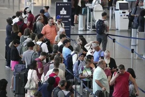 Passengers wait in line for assistance at the Delta Terminal, July 19, 2024, at Logan International Airport in Boston. Delta CEO Ed Bastian says the airline is facing $500 million in costs for the global technology breakdown that happened earlier this month. (AP Photo/Michael Dwyer, File)