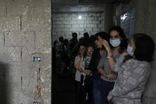 Lebanese women line up to vote at a Druze religious institute in the mountain town of Aley east of Beirut, Lebanon, Sunday, May 15, 2022. Lebanese voted for a new parliament Sunday against the backdrop of an economic meltdown that is transforming the country and low expectations that the election would significantly alter the political landscape. (AP Photo/Hassan Ammar)