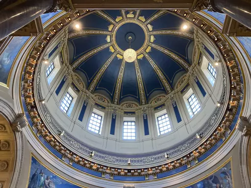 The "electrolier" is lit in the Minnesota State Capitol dome in St. Paul, Minn., Thursday, May 11, 2023, to mark Statehood Day, Minnesota's 165th birthday. The electrolier," an old term for "electric chandelier," is over 100 years old, dating from when electricity was new. It measures 6 feet in diameter, contains 92 light bulbs and hangs over 140 feet above the floor in the Capitol Rotunda. It's lit only on special occasions, such as the annual Statehood Day or on the first days of legislative s