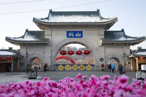 Tourists walk past a gateway with the name "Beishan" seen at the Beishan Park in northeastern China's Jilin province on Jan 23, 2020. Four instructors from Iowa's Cornell College teaching at Beihua University in northeastern China were attacked in the Beishan public park, reportedly with a knife, officials at the U.S. school and the State Department said Tuesday, June 11, 2024. (Zhu Wanchang/CNS Photos via AP)