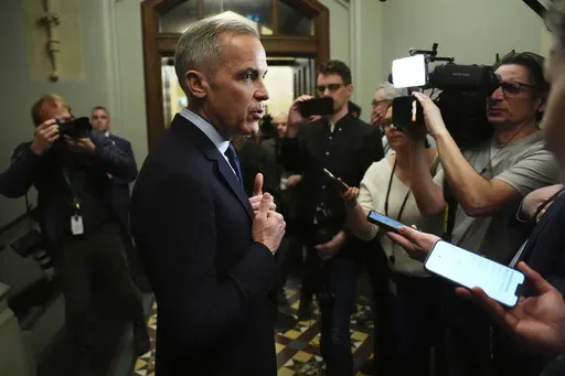 Canada Liberal Leader Mark Carney talks to media as he leaves a caucus meeting in Ottawa, Monday, March 10, 2025. (Sean Kilpatrick/The Canadian Press via AP)