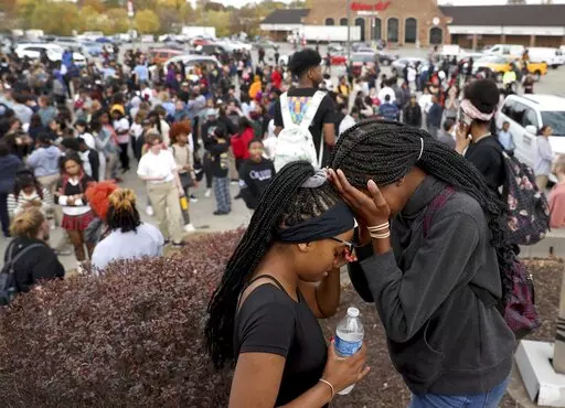 Students stand in a parking lot near the Central Visual & Performing Arts High School after a reported shooting at the school in St. Louis on Monday, Oct. 24, 2022. (David Carson/St. Louis Post-Dispatch via AP)