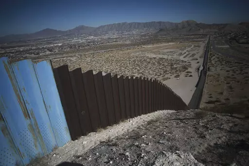 An older section of the border wall divides Ciudad Juarez, Mexico from Sunland Park, New Mexico, top, on the outskirts of Ciudad Juarez, Mexico, Tuesday, Jan. 12, 2021.  On Friday, March 4, 2022, The Associated Press reported on stories circulating online incorrectly claiming the $6 billion in aid President Joe Biden is seeking for Ukraine would have been enough to fund former President Donald Trump’s entire southern border wall project.  (AP Photo/Christian Chavez, File)