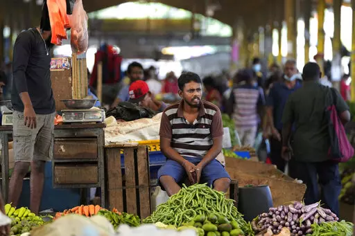A vender waits for customers at a vegetable market place in Colombo, Sri Lanka, Friday, June 10, 2022. Some 1.6 billion people in 94 countries face at least one dimension of the crisis in food, energy and financial systems, according to a report last month by the Global Crisis Response Group of the United Nations Secretary-General. (AP Photo/Eranga Jayawardena, File)