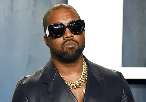 Kanye West arrives at the Vanity Fair Oscar Party on Feb. 9, 2020, in Beverly Hills, Calif. The rapper formerly known as Kanye West is offering to buy right-wing friendly social network Parler after being booted off of Twitter and Instagram. (Photo by Evan Agostini/Invision/AP, File)