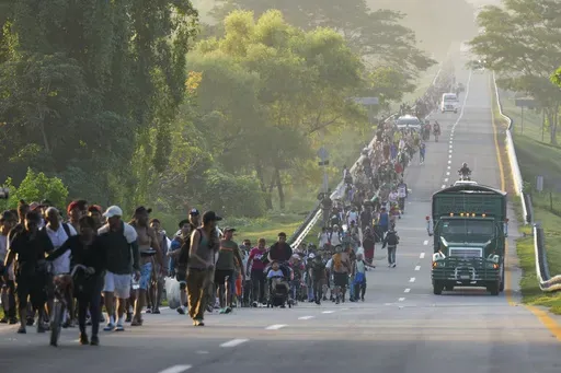 Migrants walk along the highway in Huixtla, southern Mexico, heading toward the country's northern border and ultimately the United States, Thursday, Nov. 7, 2024. (AP Photo/Moises Castillo)