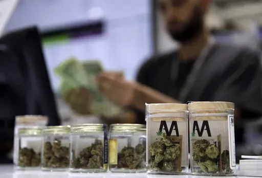 A cashier rings up a marijuana sale, July 1, 2017, at a cannabis dispensary in Las Vegas. (AP Photo/John Locher, File)
