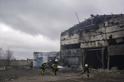Firefighters try to extinguish the fire at a damaged factory following a Russian bombing in Kramatorsk, Ukraine, Thursday, April 14, 2022. (AP Photo/Petros Giannakouris)