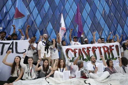 Demonstrators participate in a protest against the Israel-Hamas war during the COP28 U.N. Climate Summit, Sunday, Dec. 3, 2023, in Dubai, United Arab Emirates. (AP Photo/Peter Dejong)