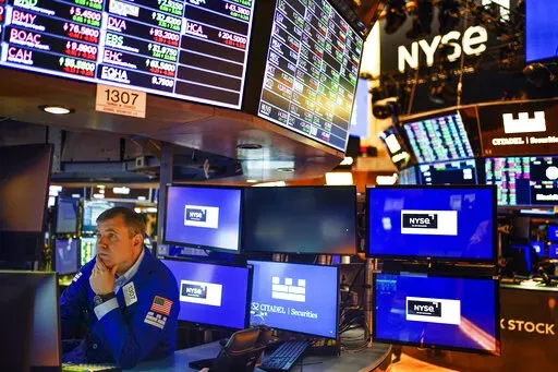 A trader works on the floor at the New York Stock Exchange in New York, Thursday, May 19, 2022. This year's sell-off for Wall Street means stocks no longer look to be in a dangerously overvalued bubble, as some critics had warned. Prices have retreated toward historical norms, when measured against corporate profits.  Analysts have so far been maintaining their expectations for corporate profits going forward.  (AP Photo/Seth Wenig, File)