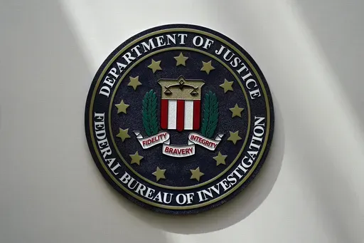 An FBI seal is seen on a wall on Aug. 10, 2022, in Omaha, Neb. Violent crime in the US dropped again in 2023, according to FBI statistics that show a continued trend downward after a coronavirus pandemic-era crime spike. The report released Monday shows overall violent crime ticked down an estimated 3% in 2023 from the year before, according to the FBI. (AP Photo/Charlie Neibergall, File)