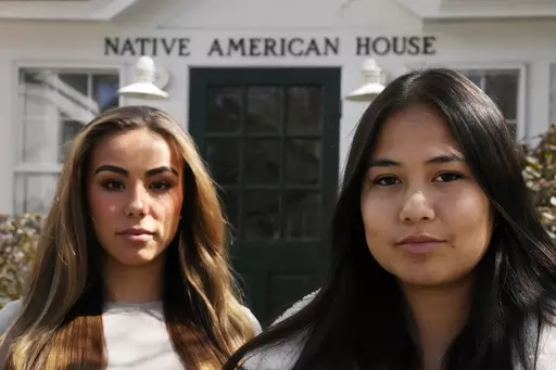 Dartmouth College students Marisa Joseph, right, a member of the Tulalip Tribes of Washington, poses with Ahnili Johnson-Jennings, left, a member of the Quapaw, Choctaw, Sac and Fox and Miami tribes, pose outside the Native American House at Dartmouth College, Friday, April 7, 2023, in Hanover, N.H. The college announced in March 2023 that it housed partial Native American skeletal remains in their collection. Dartmouth has set in motion an effort to repatriate the remains to the appropriate tri