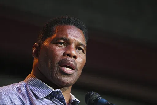 Herschel Walker, Republican candidate for U.S. Senate for Georgia, speaks at a primary watch party on May 23, 2022, at the Foundry restaurant in Athens, Ga. A woman who said Walker paid for her 2009 abortion is the mother of one of his children, according to a new report released Wednesday, Oct. 5, 2022, undercutting the Republican Senate candidate's claims that he did not know who she was. (AP Photo/Akili-Casundria Ramsess, File)