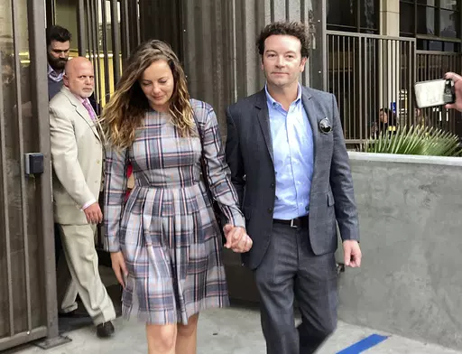 Actor Danny Masterson leaves Los Angeles superior Court with his wife Bijou Phillips after a judge declared a mistrial in his rape case in Los Angeles on Nov. 30, 2022. Masterson is going back on trial on three charges of rape. A deadlocked jury led to a mistrial for Masterson in November. Opening statements in his retrial will begin on Monday. (AP Photo/Brian Melley, File)