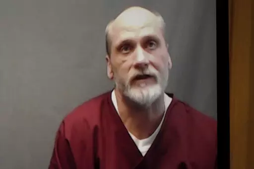 In this photo from a video screen, death row inmate James Coddington speaks to the Oklahoma Board of Pardon and Parole on Wednesday, Aug. 3, 2022, in Oklahoma City. Oklahoma Gov. Kevin Stitt has rejected clemency for  Coddington, who is facing execution for the 1997 hammer killing of a man. Stitt’s decision on Wednesday, Aug. 24, 2022,  paves the way for Coddington to be executed by lethal injection on Thursday.  (AP Photo/Sue Ogrocki, File)