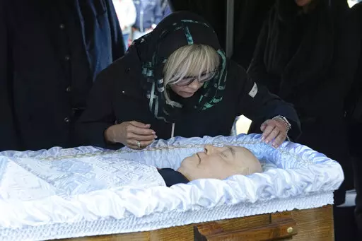 Irina Virganskaya, daughter of former Soviet Union President Mikhail Gorbachev says goodbye to him for the last time, during his funeral, at Novodevichy Cemetery in Moscow, Russia, Saturday, Sept. 3, 2022. Thousands of mourners lined up Saturday to pay tribute to former Soviet leader Mikhail Gorbachev, who launched drastic reforms that helped end the Cold War and precipitated the breakup of the Soviet Union. Gorbachev died Tuesday, Aug. 30, 2022 at the age of 91.  (AP Photo/Alexander Zemlianiche
