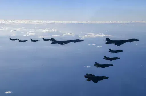 In this photo provided by South Korean Defense Ministry, two U.S. Air Force B-1B bombers, top center, four South Korean Air Force F-35 fighter jets and four US Air Force F-16 fighter jets fly over South Korea Peninsula during a joint air drill called "Vigilant Storm," in South Korea, Saturday, Nov. 5, 2022. North Korea added to its recent barrage of weapons demonstrations by launching four ballistic missiles into the sea on Saturday, as the United States sent two supersonic bombers streaking ove