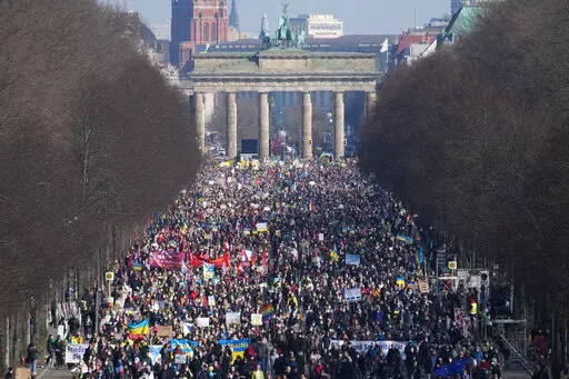 People attend a pro-Ukraine protest rally in Berlin, Germany, Sunday, March 13, 2022. On Thursday, Feb. 24, 2022 Russian troops have launched their anticipated attack on Ukraine. (AP Photo/Michael Sohn)