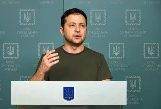 In this photo, Feb. 27, 2022, taken from video provided by the Ukrainian Presidential Press Office, Ukrainian President Volodymyr Zelenskyy speaks to the nation in Kyiv, Ukraine.  Russian state media is spreading false claims that Ukrainian President Volodymyr Zelenskyy has fled Kyiv in what experts say is an effort to discourage Ukrainians and erode support for Ukraine around the globe.  (Ukrainian Presidential Press Office via AP, File)