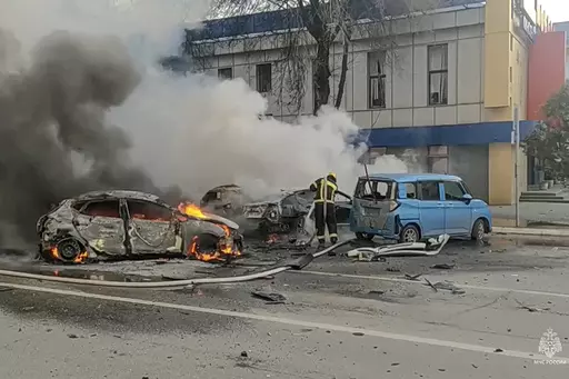 In this photo taken from video released by Russia Emergency Situations Ministry telegram channel on Dec. 30, 2023, firefighters extinguish burning cars after shelling in Belgorod, Russia. Belgorod has canceled its traditional Orthodox Epiphany festivities on Friday, Jan. 19, 2024 due to the threat of attacks as Kyiv's forces pursue a new strategy with the war approaching its two-year milestone. (Russia Emergency Situations Ministry telegram channel via AP, File)
