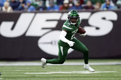 New York Jets wide receiver Elijah Moore (8) runs with the ball against the Detroit Lions during an NFL football game Sunday, Dec. 18, 2022, in East Rutherford, N.J. Moore spoke excitedly on Thursday, March 23, 2023, about joining the Cleveland Browns, who looking for another playmaker for QB Deshaun Watson and some needed speed, acquired him from the Jets in exchange for the No. 42 pick in this year's draft.(AP Photo/Adam Hunger, File)